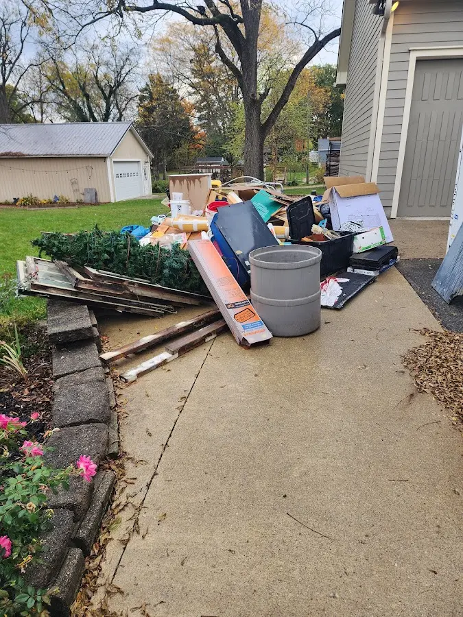 Dumpster being loaded with debris for Estate Cleanout Dumpster Rental in Flower Hill